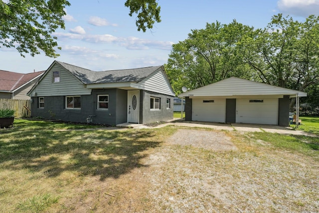 1366 Brown Rd, Columbus, OH 43223 - view of front of property featuring a garage, an outdoor structure, roof with shingles, and driveway
