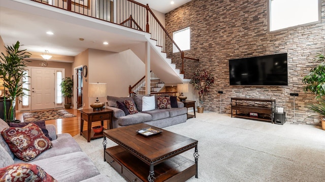 8933 Winding Creek Way, Pickerington, OH 43147 - carpeted living room featuring a towering ceiling, stairway, and recessed lighting