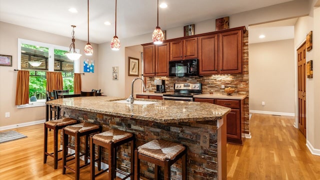 8933 Winding Creek Way, Pickerington, OH 43147 - kitchen with black microwave, stainless steel electric range, light wood-style flooring, tasteful backsplash, and recessed lighting