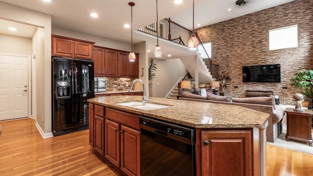 8933 Winding Creek Way, Pickerington, OH 43147 - kitchen featuring black appliances, light wood-type flooring, open floor plan, an island with sink, and recessed lighting