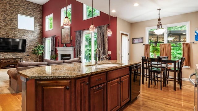 8933 Winding Creek Way, Pickerington, OH 43147 - kitchen with light wood-type flooring, a fireplace, pendant lighting, and recessed lighting