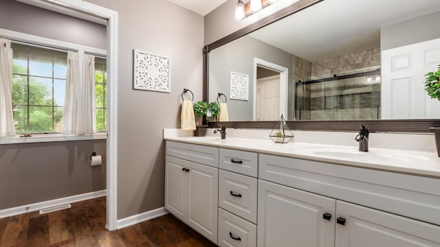 8933 Winding Creek Way, Pickerington, OH 43147 - bathroom with double vanity, a shower stall, and wood finished floors