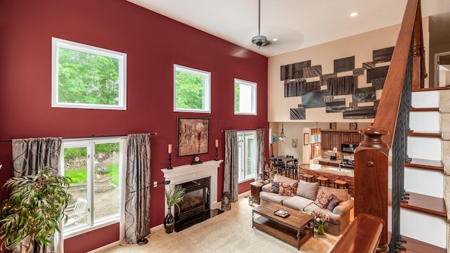 8933 Winding Creek Way, Pickerington, OH 43147 - carpeted living room with a high end fireplace, stairway, a high ceiling, and recessed lighting