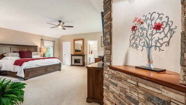 8933 Winding Creek Way, Pickerington, OH 43147 - carpeted bedroom featuring a stone fireplace, lofted ceiling, a ceiling fan, and connected bathroom