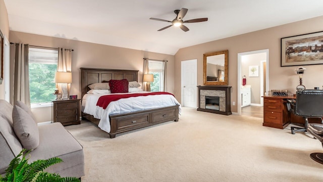 8933 Winding Creek Way, Pickerington, OH 43147 - bedroom featuring a stone fireplace, light carpet, lofted ceiling, an office area, and connected bathroom