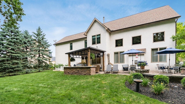 8933 Winding Creek Way, Pickerington, OH 43147 - back of property featuring a patio area, a yard, and stucco siding