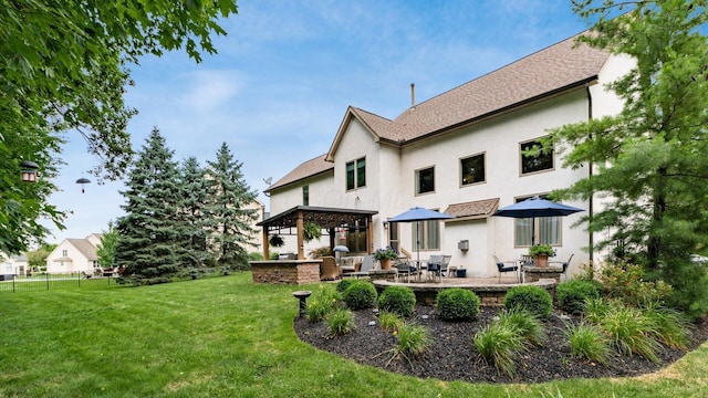 8933 Winding Creek Way, Pickerington, OH 43147 - rear view of house featuring stucco siding, a lawn, and a patio area