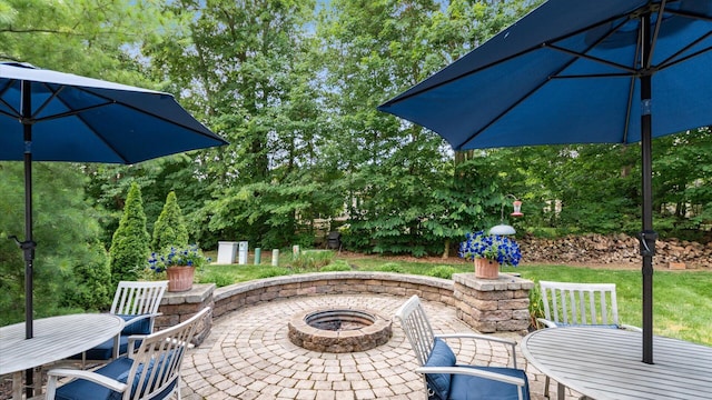 8933 Winding Creek Way, Pickerington, OH 43147 - view of patio / terrace with a fire pit, outdoor dining space, and view of scattered trees