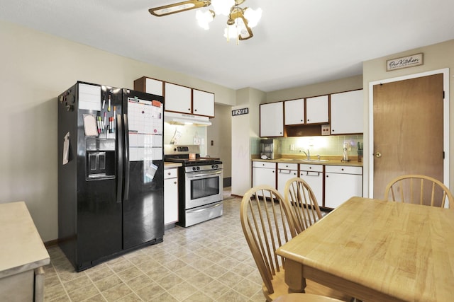 3905 Frazier Rd E, Columbus, OH 43207 - kitchen featuring black refrigerator with ice dispenser, stainless steel gas stove, dishwasher, under cabinet range hood, and white cabinetry