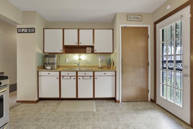 3905 Frazier Rd E, Columbus, OH 43207 - kitchen featuring decorative backsplash, white cabinets, light countertops, and range