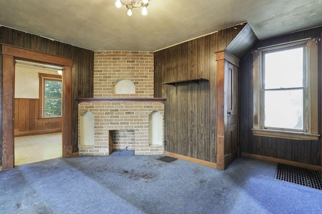 141 W Waterloo St, Canal Winchester, OH 43110 - unfurnished living room featuring wooden walls, carpet, and a brick fireplace