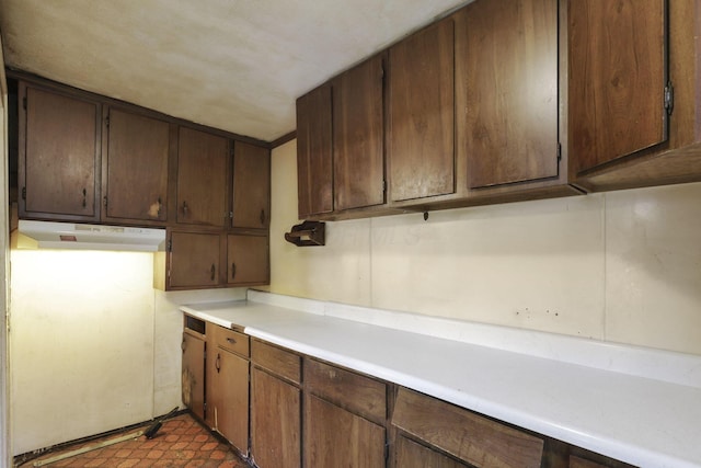 141 W Waterloo St, Canal Winchester, OH 43110 - kitchen featuring under cabinet range hood, light countertops, tile patterned floors, and dark brown cabinets