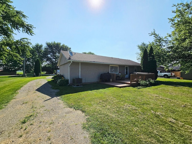 4999 Dickey Rd NE, Bloomingburg, OH 43106 - back of property featuring a deck, a lawn, and dirt driveway