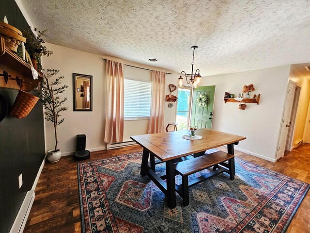 4999 Dickey Rd NE, Bloomingburg, OH 43106 - dining room featuring a textured ceiling, baseboard heating, wood finished floors, and a chandelier