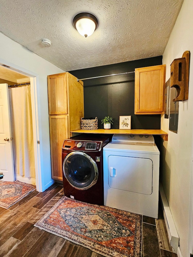 4999 Dickey Rd NE, Bloomingburg, OH 43106 - washroom featuring cabinet space, washing machine and dryer, a textured ceiling, and dark wood finished floors