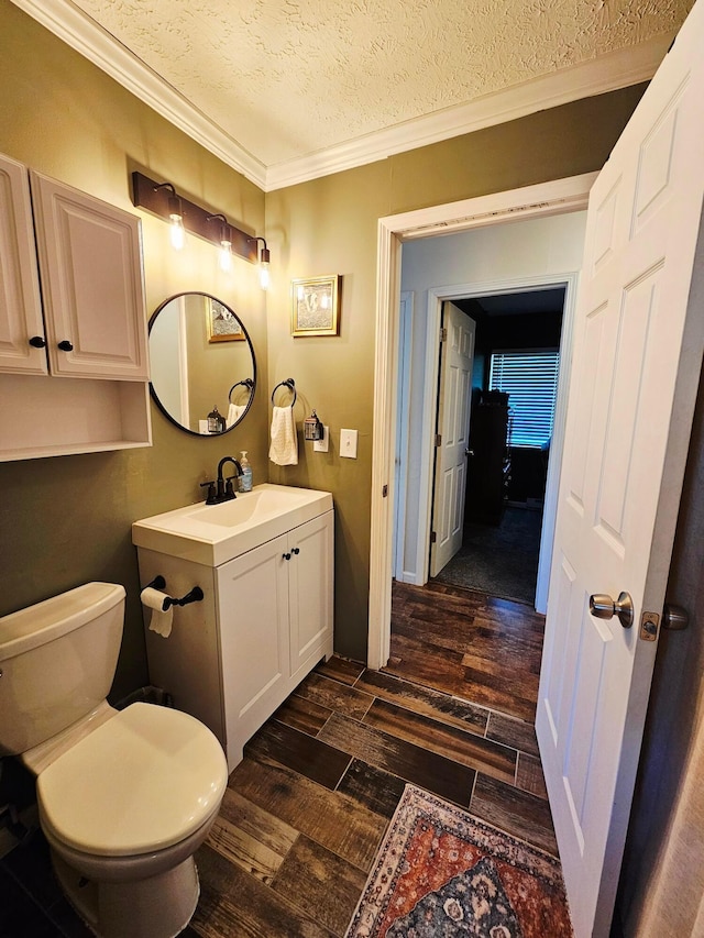 4999 Dickey Rd NE, Bloomingburg, OH 43106 - bathroom featuring wood finished floors, crown molding, a textured ceiling, and vanity