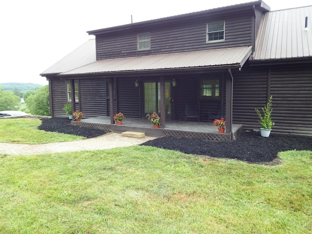 19448 Cr-80, Warsaw, OH 43844 - back of house featuring faux log siding, a yard, a metal roof, and covered porch