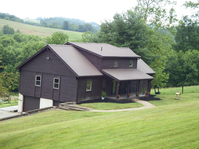 19448 Cr-80, Warsaw, OH 43844 - back of house featuring a yard, a garage, a metal roof, and concrete driveway