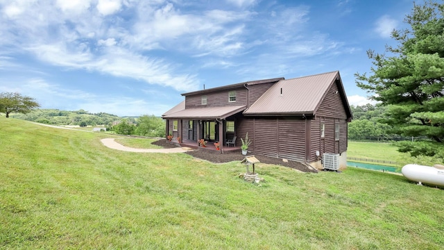 19448 Cr-80, Warsaw, OH 43844 - rear view of property featuring a yard, faux log siding, and a metal roof