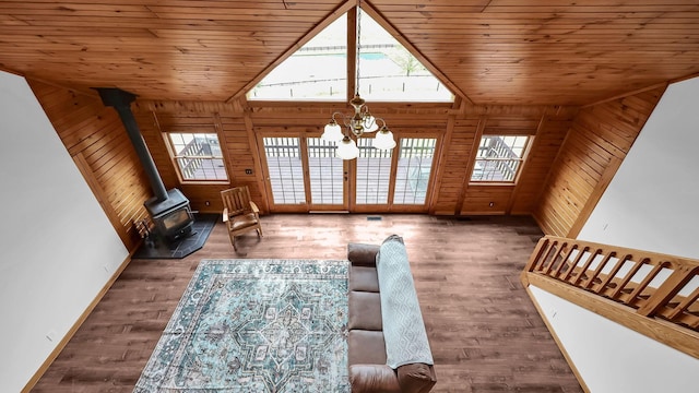 19448 Cr-80, Warsaw, OH 43844 - living room with a wood stove, a chandelier, plenty of natural light, wood walls, and wood finished floors
