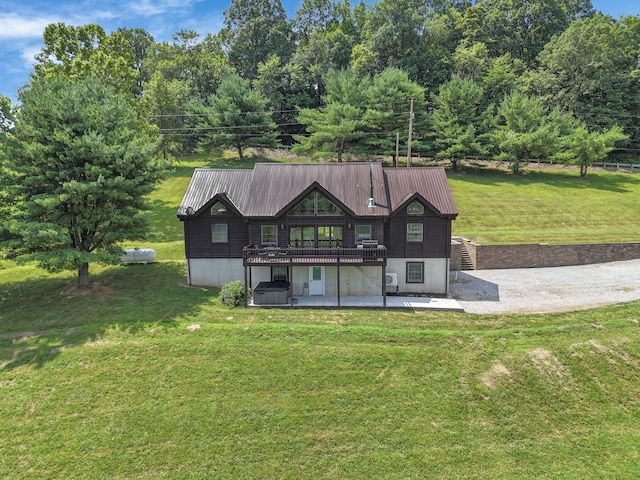 19448 Cr-80, Warsaw, OH 43844 - rear view of property featuring a lawn, a patio area, a wooden deck, and a metal roof