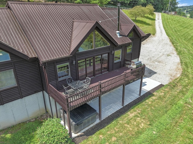 19448 Cr-80, Warsaw, OH 43844 - rear view of house featuring log veneer siding, a metal roof, a lawn, and a patio