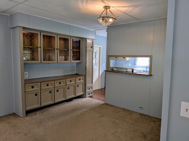8927 Columbus Rd Lot 44, Mount Vernon, OH 43050 - kitchen with carpet flooring, glass insert cabinets, and hanging light fixtures