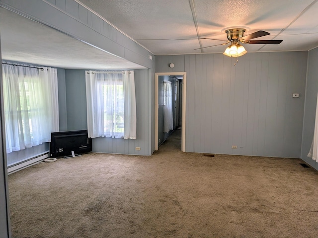8927 Columbus Rd Lot 44, Mount Vernon, OH 43050 - carpeted spare room with a baseboard radiator, a ceiling fan, and a textured ceiling