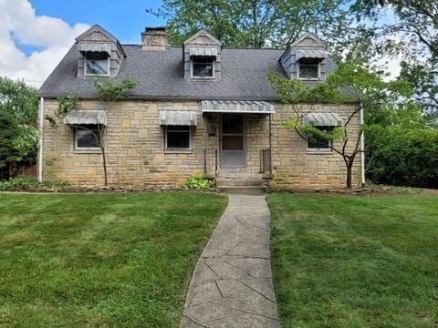 808 Montrose Ave, Columbus, OH 43209 - new england style home with stone siding, a front lawn, and a chimney