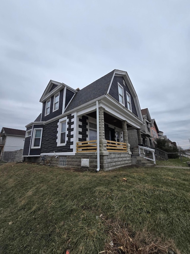 1035 Sullivant Ave, Columbus, OH 43223 - view of property exterior with a yard, a shingled roof, and covered porch