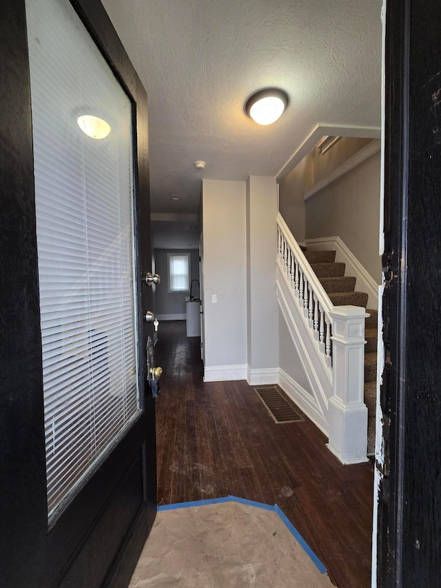 1035 Sullivant Ave, Columbus, OH 43223 - foyer entrance featuring hardwood / wood-style flooring, a textured ceiling, and stairway