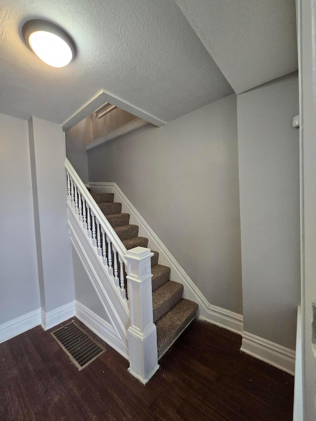 1035 Sullivant Ave, Columbus, OH 43223 - staircase featuring wood finished floors and a textured ceiling