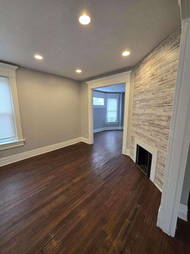 1035 Sullivant Ave, Columbus, OH 43223 - unfurnished living room with dark wood-style flooring, a fireplace, and recessed lighting