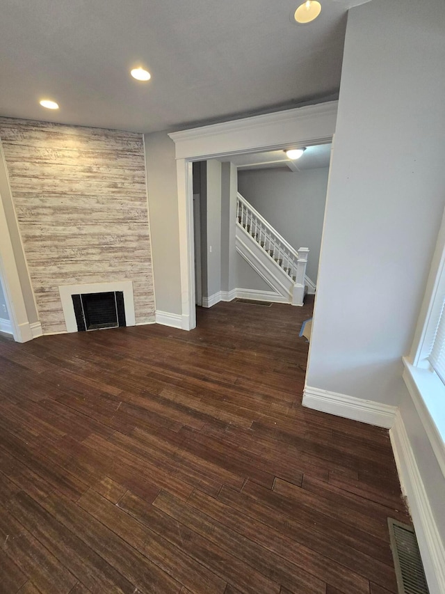 1035 Sullivant Ave, Columbus, OH 43223 - unfurnished living room with stairs, wood finished floors, recessed lighting, and a large fireplace