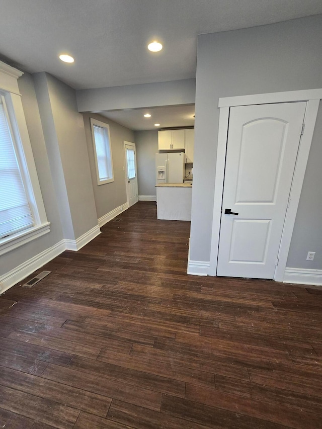 1035 Sullivant Ave, Columbus, OH 43223 - unfurnished living room featuring dark wood-type flooring and recessed lighting