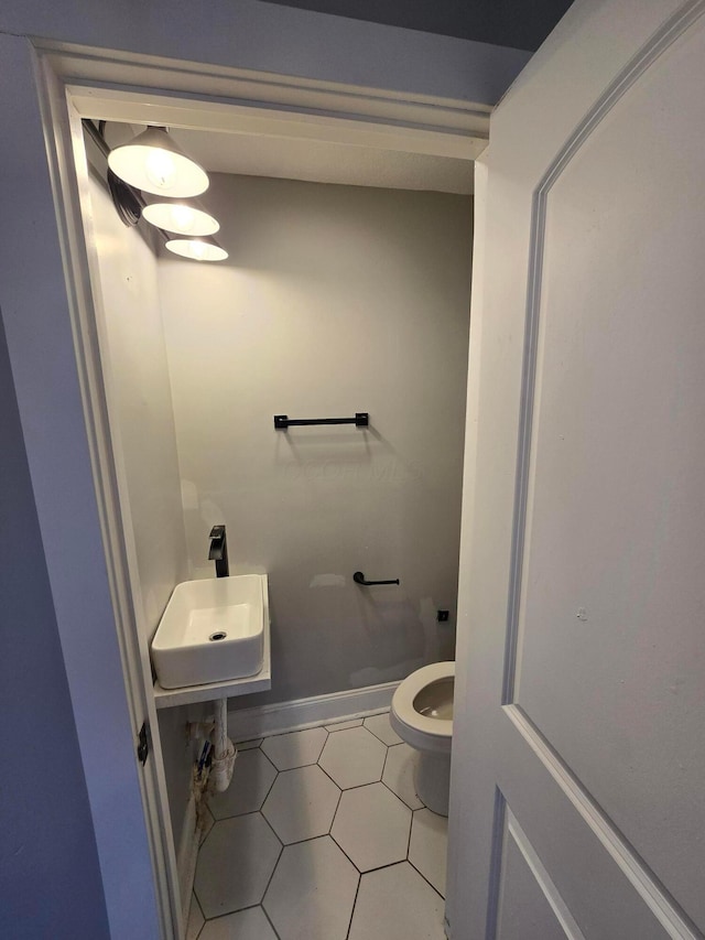 1035 Sullivant Ave, Columbus, OH 43223 - half bath featuring toilet and tile patterned flooring