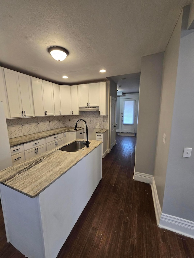 1035 Sullivant Ave, Columbus, OH 43223 - kitchen featuring dark wood-style flooring, white cabinets, tasteful backsplash, a textured ceiling, and light stone countertops