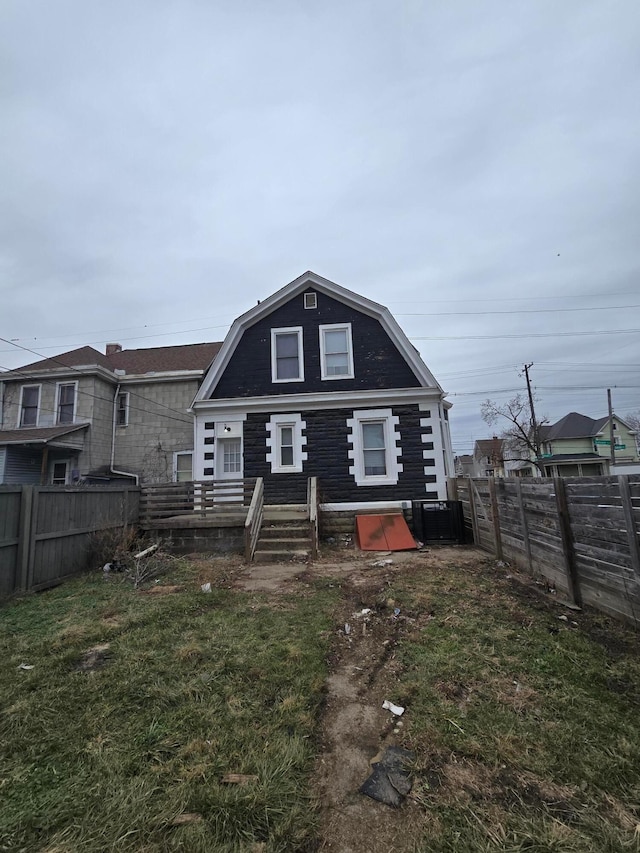 1035 Sullivant Ave, Columbus, OH 43223 - back of house featuring a gambrel roof and a fenced backyard