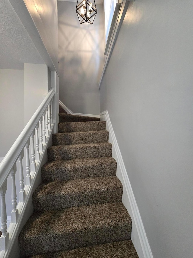 1035 Sullivant Ave, Columbus, OH 43223 - staircase with a chandelier