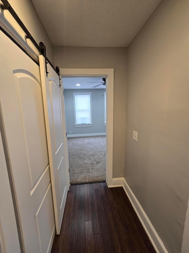 1035 Sullivant Ave, Columbus, OH 43223 - hallway with a barn door and dark wood-style flooring