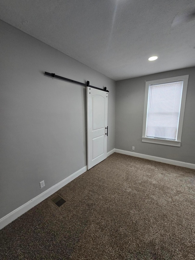 1035 Sullivant Ave, Columbus, OH 43223 - empty room with a barn door and carpet floors