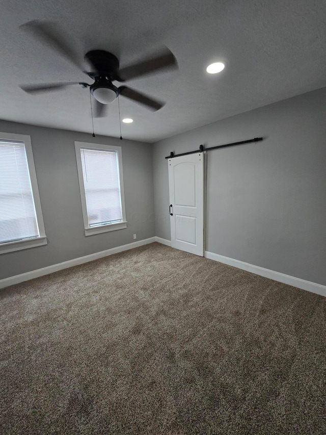 1035 Sullivant Ave, Columbus, OH 43223 - unfurnished bedroom featuring a barn door, multiple windows, carpet flooring, recessed lighting, and a ceiling fan