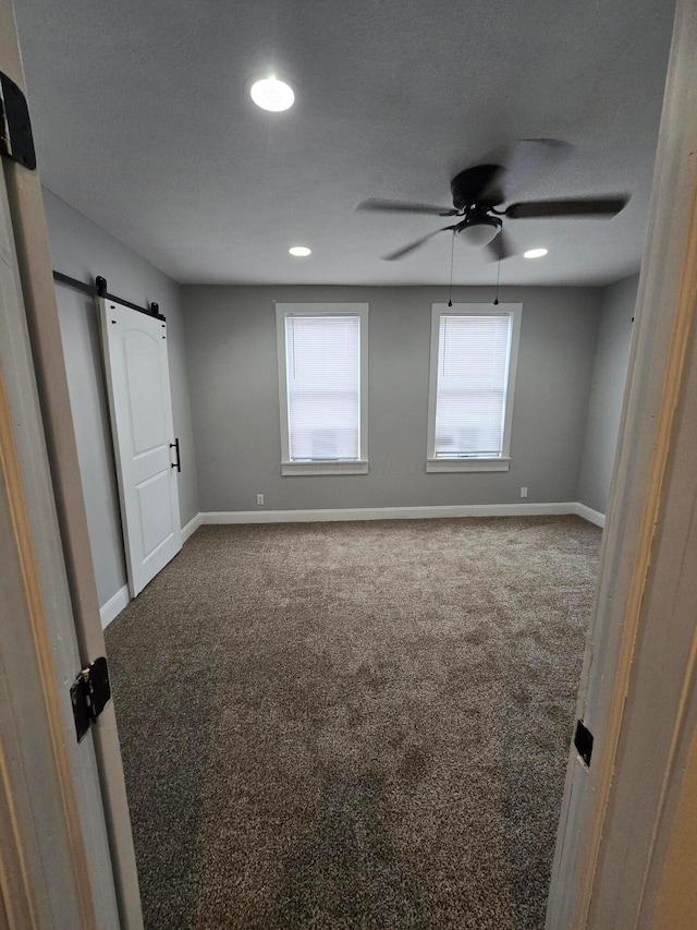 1035 Sullivant Ave, Columbus, OH 43223 - unfurnished bedroom featuring a barn door, carpet flooring, recessed lighting, and ceiling fan