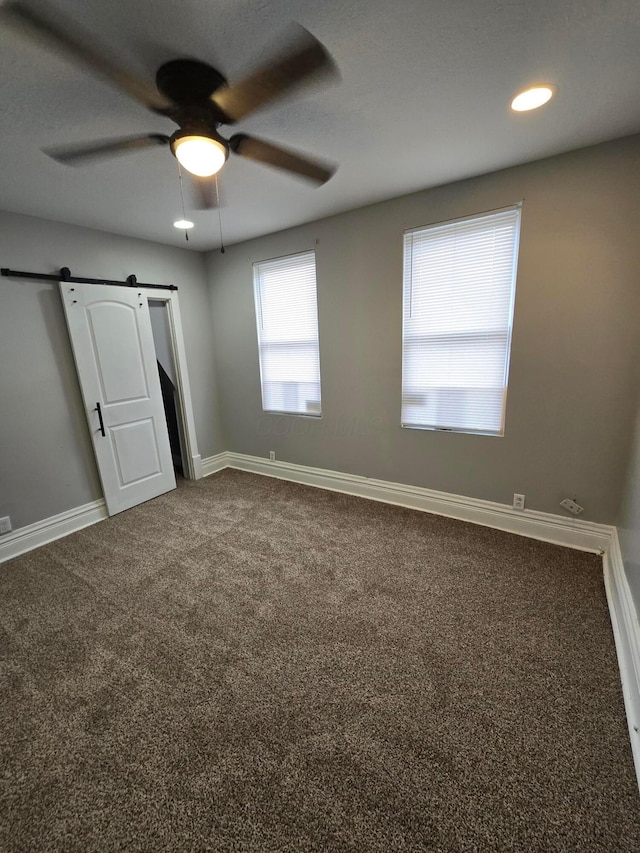 1035 Sullivant Ave, Columbus, OH 43223 - unfurnished bedroom with a barn door, carpet floors, recessed lighting, and a ceiling fan