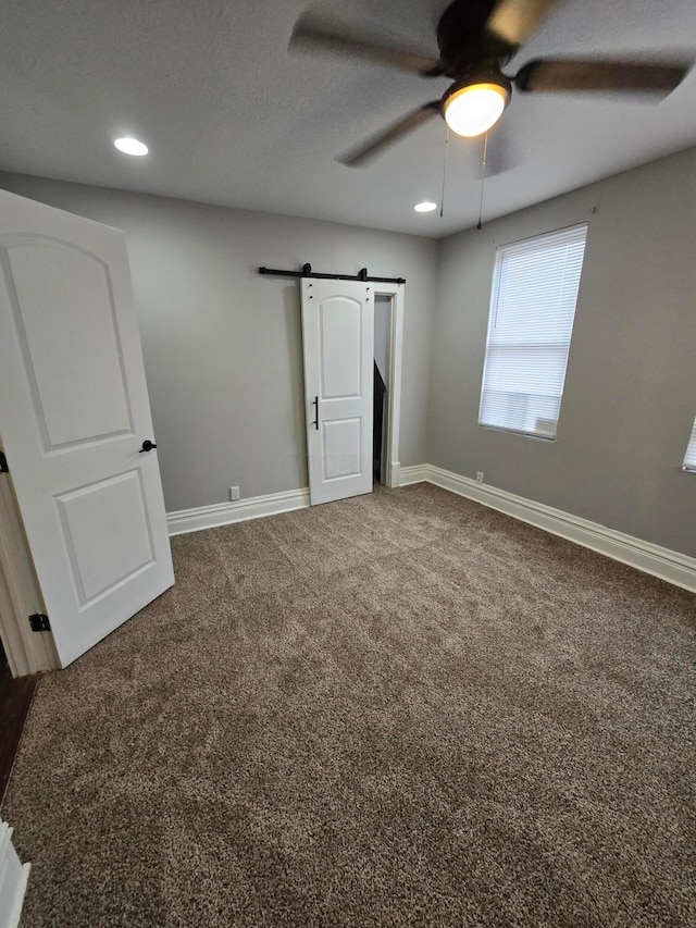 1035 Sullivant Ave, Columbus, OH 43223 - unfurnished bedroom featuring carpet floors, a barn door, recessed lighting, and ceiling fan