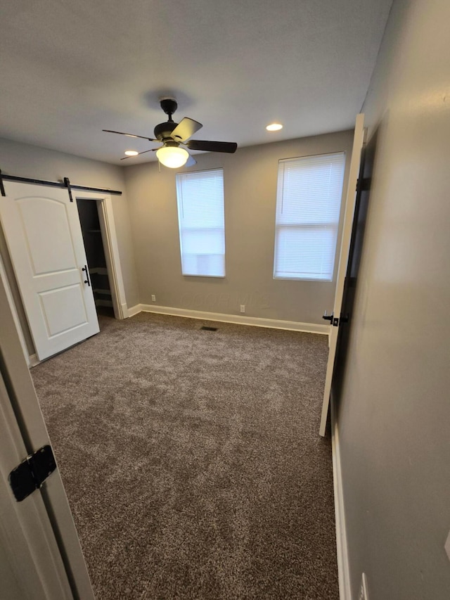 1035 Sullivant Ave, Columbus, OH 43223 - unfurnished bedroom featuring carpet floors, a barn door, a ceiling fan, and recessed lighting