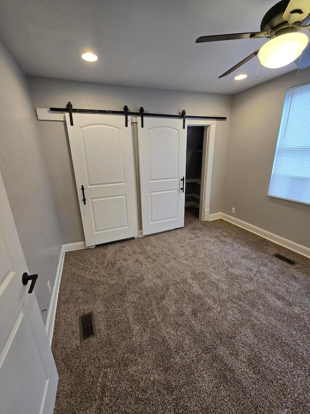 1035 Sullivant Ave, Columbus, OH 43223 - unfurnished bedroom featuring a barn door, carpet, recessed lighting, and a ceiling fan