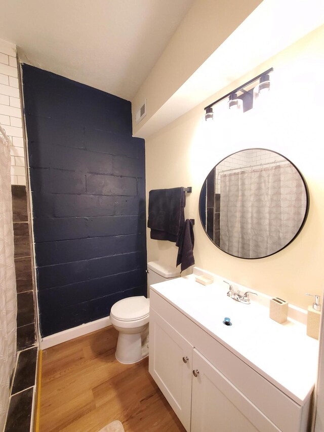 345 Dakota Ave, Columbus, OH 43223 - bathroom with wood finished floors, vanity, and a shower with shower curtain