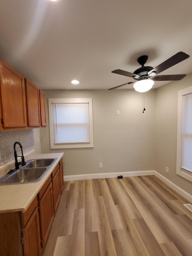 345 Dakota Ave, Columbus, OH 43223 - kitchen with brown cabinets, light countertops, light wood-style floors, a ceiling fan, and recessed lighting