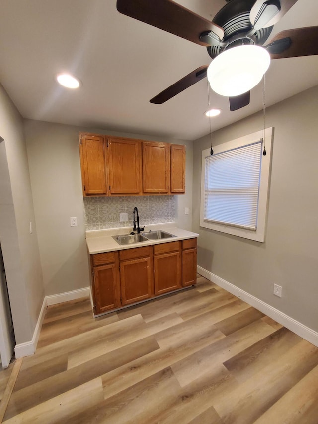 345 Dakota Ave, Columbus, OH 43223 - kitchen with ceiling fan, brown cabinets, backsplash, light countertops, and recessed lighting